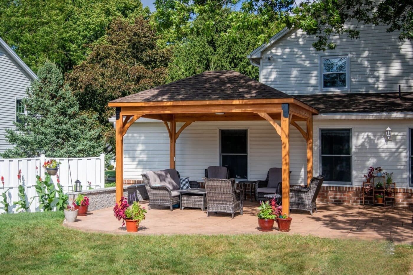 Full view of wooden Lakefront Pavilion behind home
