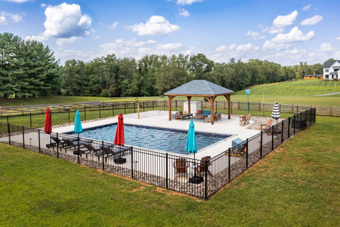Aerial shot of 12x16 Cheyenne Wood Pavilion with pool and gated area