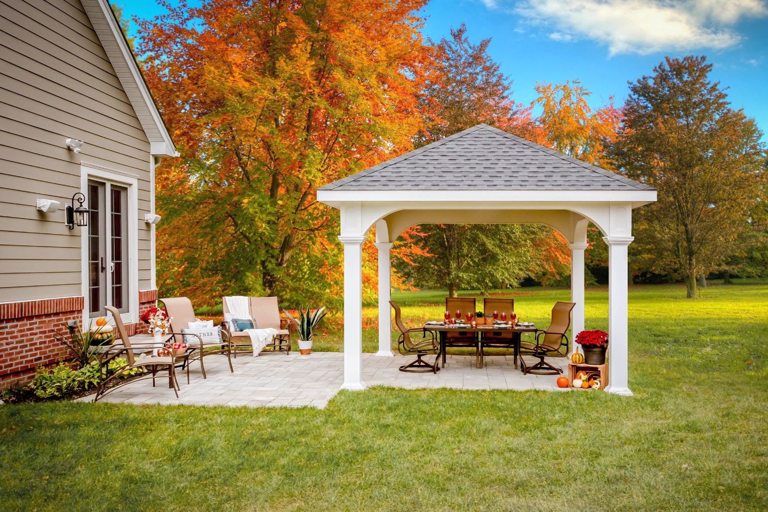 White Vinyl Montford Pavilion over patio seating area in fall backyard
