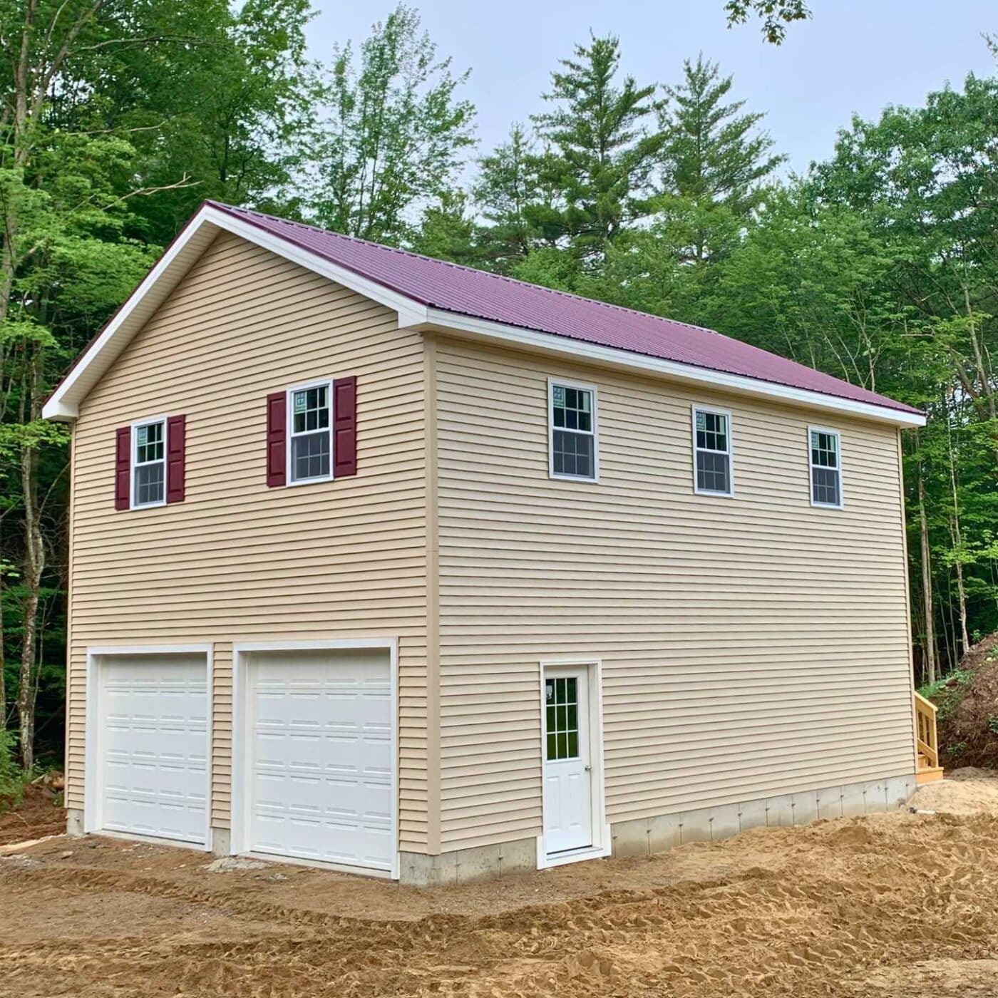 The A-Frame Two Story Garage 2 Tan vinyl two-story garage with red shutters and red roof