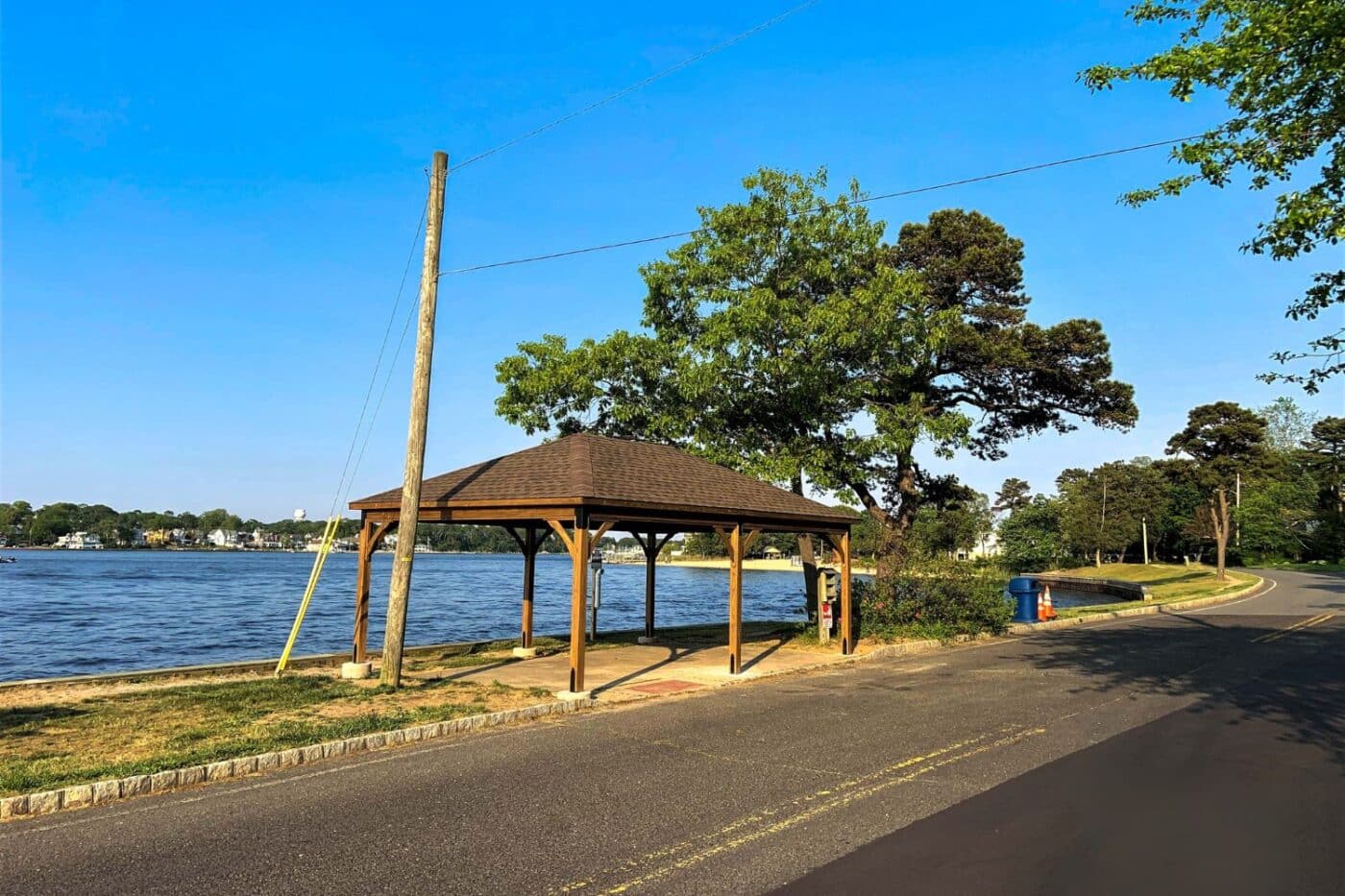 Lakefront wood pavilion view form road