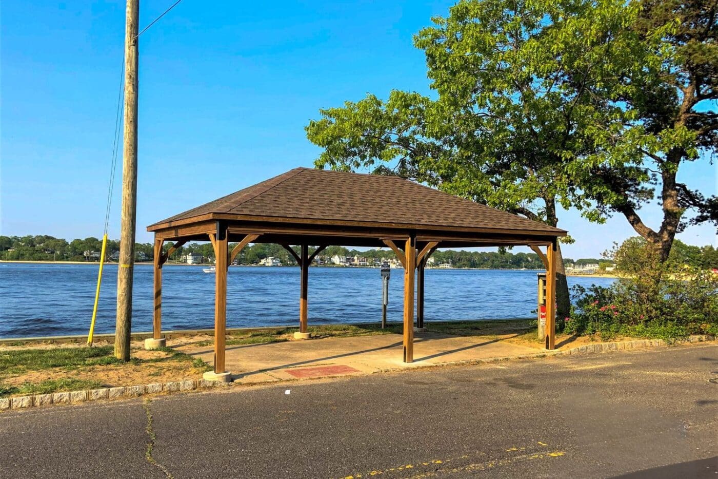 Back view of lakeside wooden pavilion in front of lake