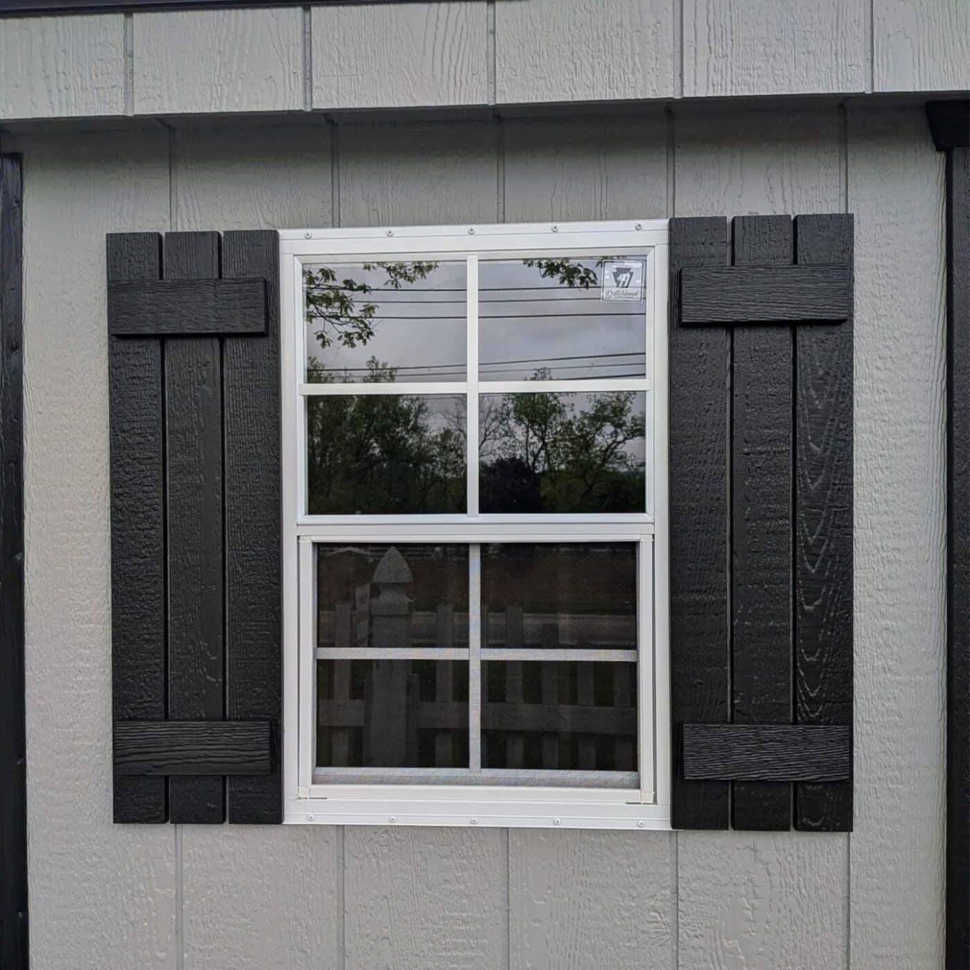 The Standard Carriage Shed 8 Gray shed with 18x27 window with black shutters