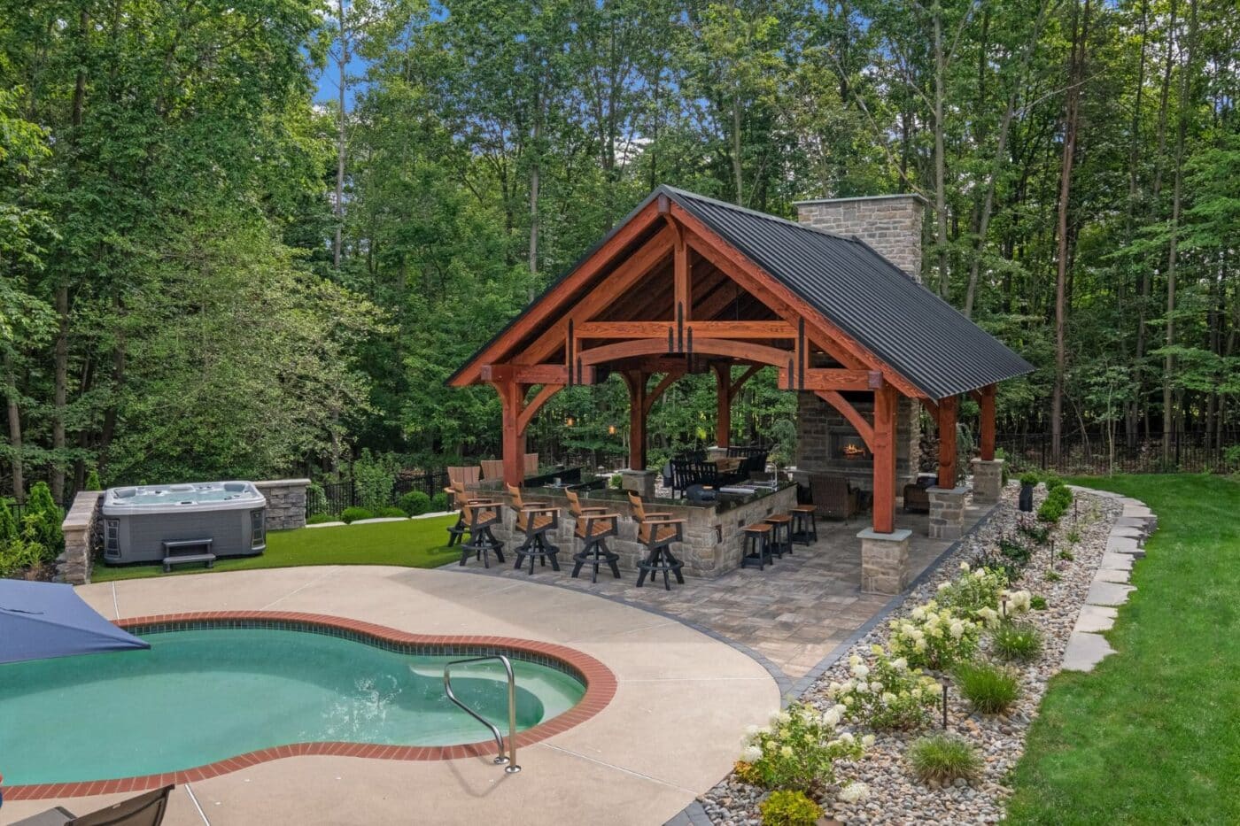 Aerial view of 20x30 Grand Teton Timber Frame Pavilion with view of pool and yard landscaping