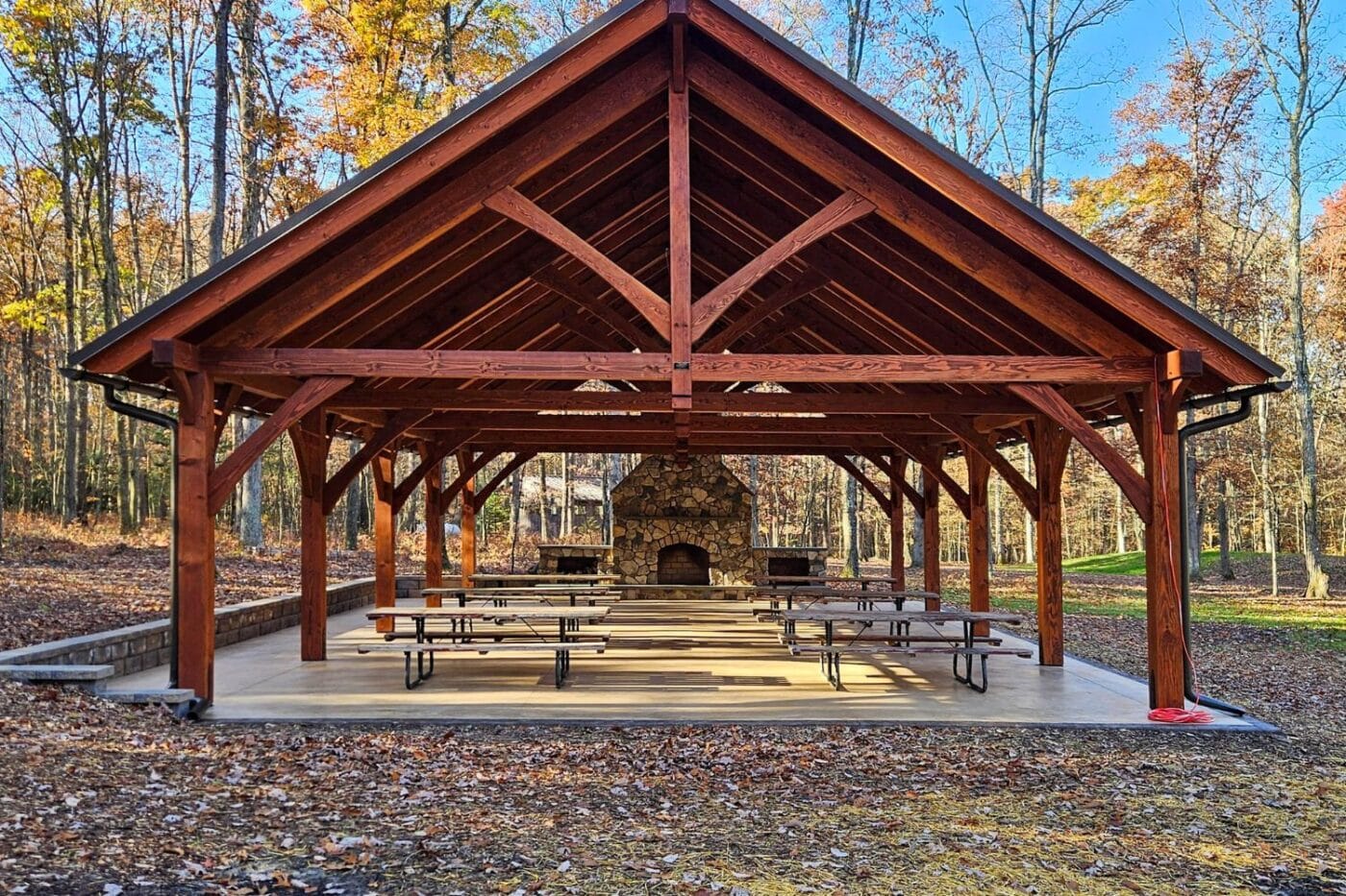 View of front of 30x50 kingston pro timber frame pavilion in autumn leaves