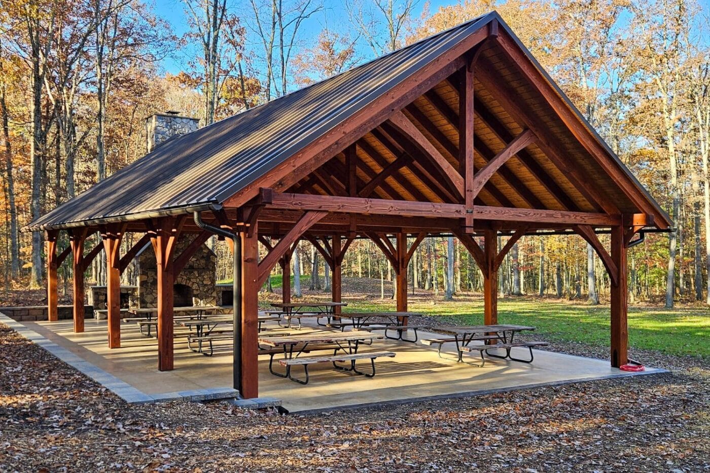 View of 30x50 kingston pro pavilion in woods with patio