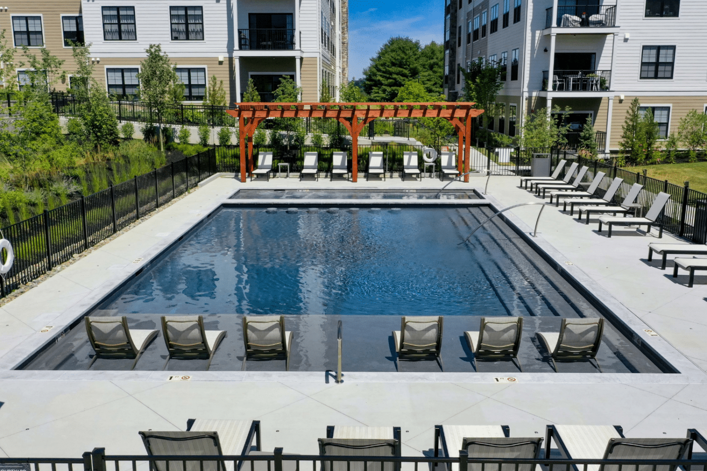 View of 7x30 Boulder Pergola across pool
