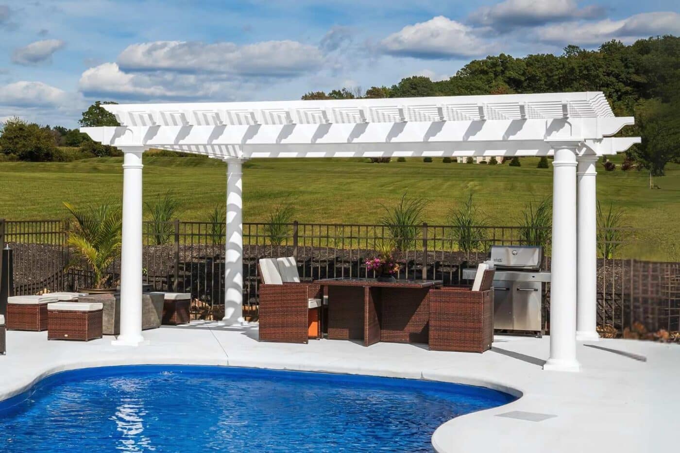 Vinyl Cancun pergola besides pool over seating area