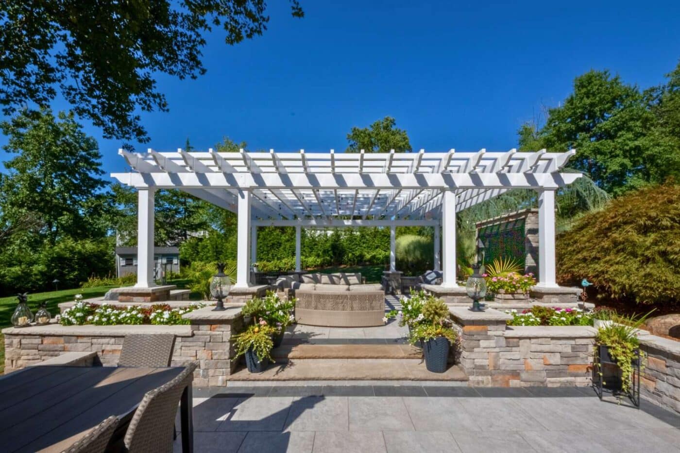 Carolina vinyl pergola over large stone garden and seating area