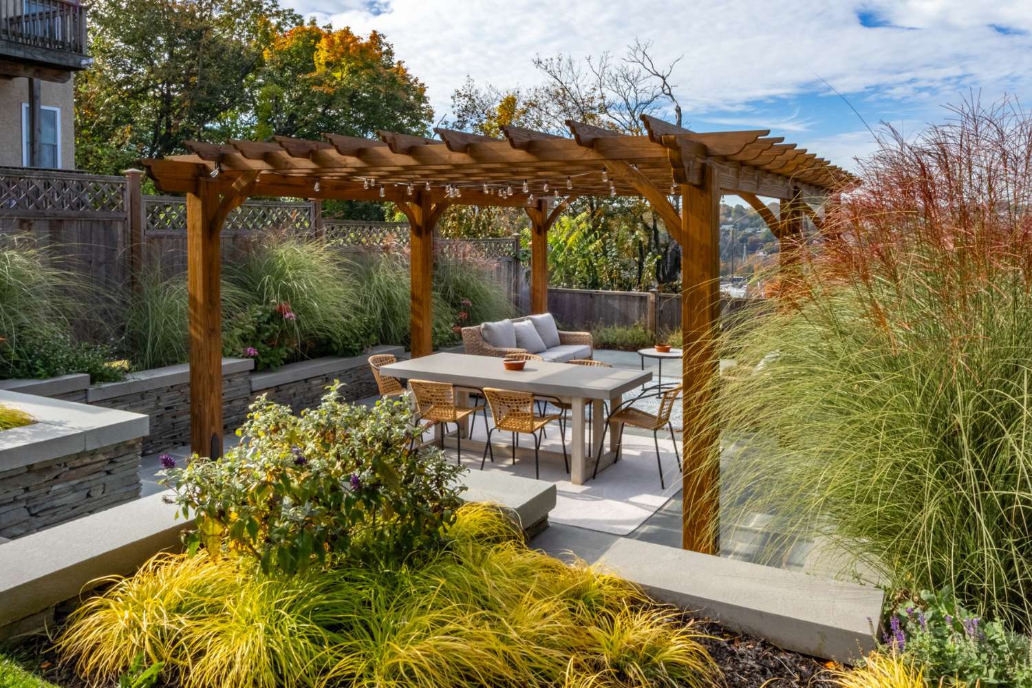 Cherokee Wooden Pergola over dining area inside garden