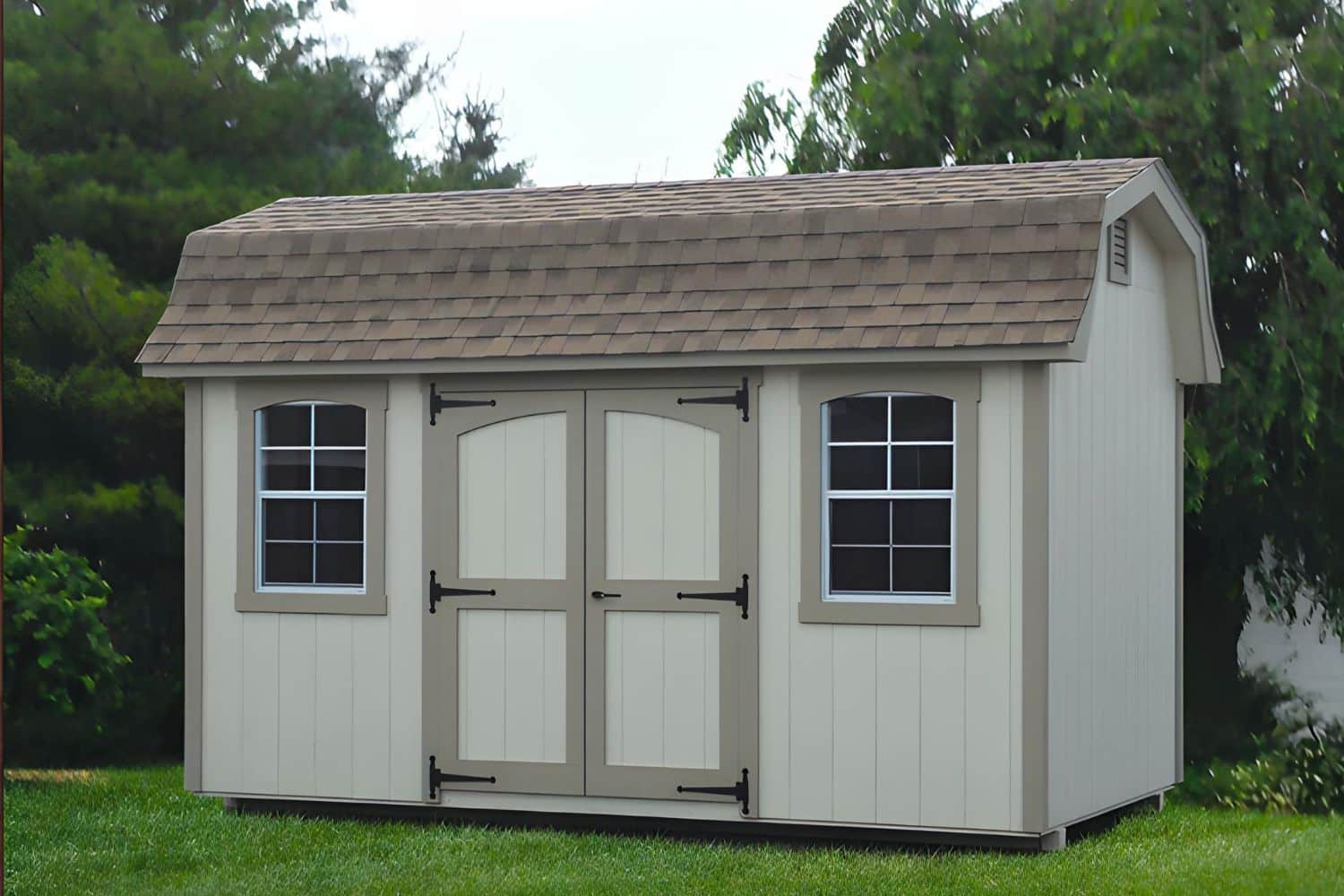 Beige and brown designer high barn in front of trees