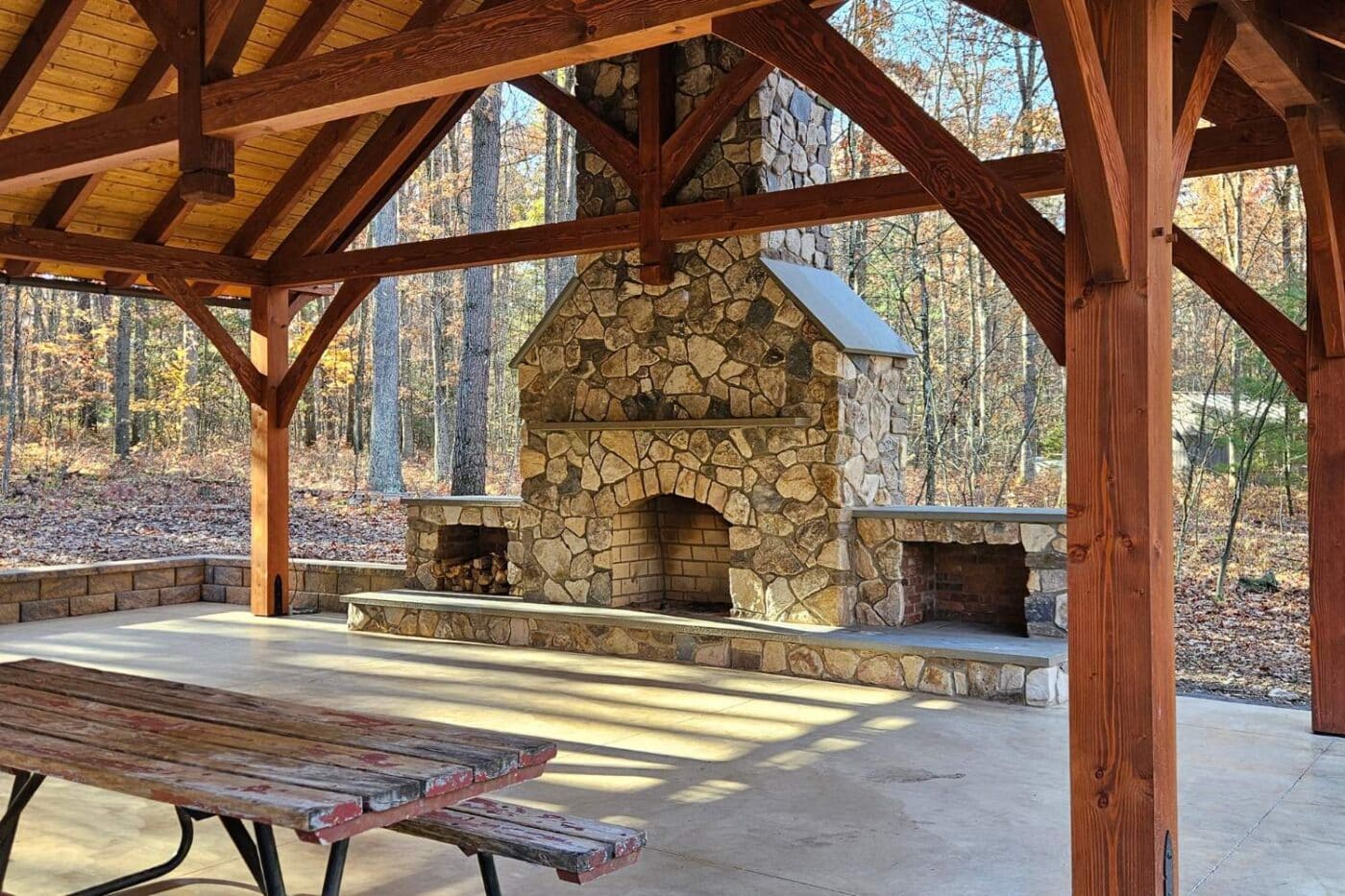 Fireplaces 1 Kingston TF Pavilion with stone fireplace, picnic benches, and gathering area