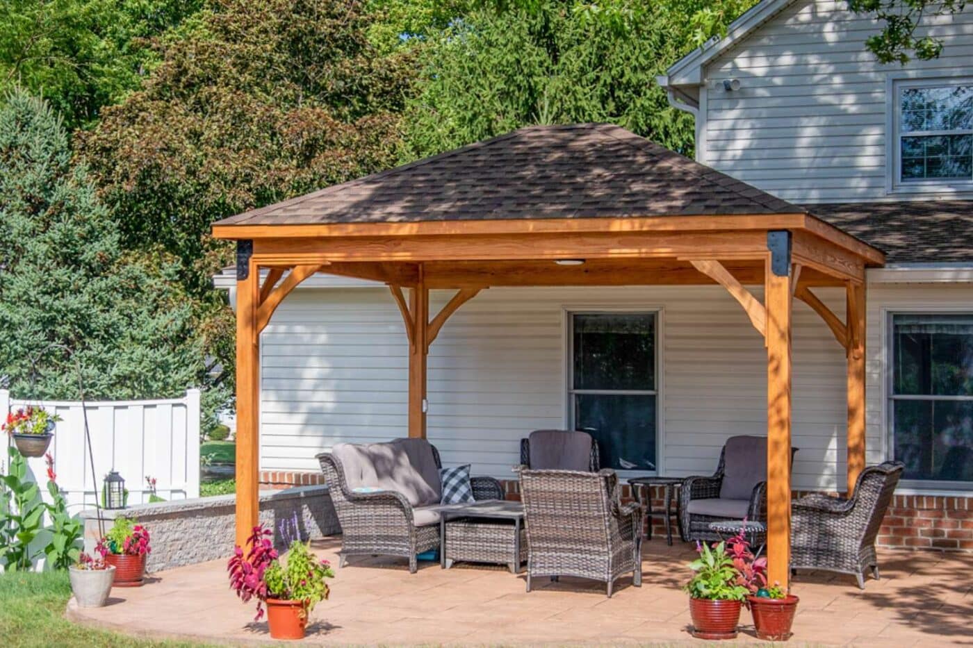 Lakefront wooden pavilion besides home and over seating area