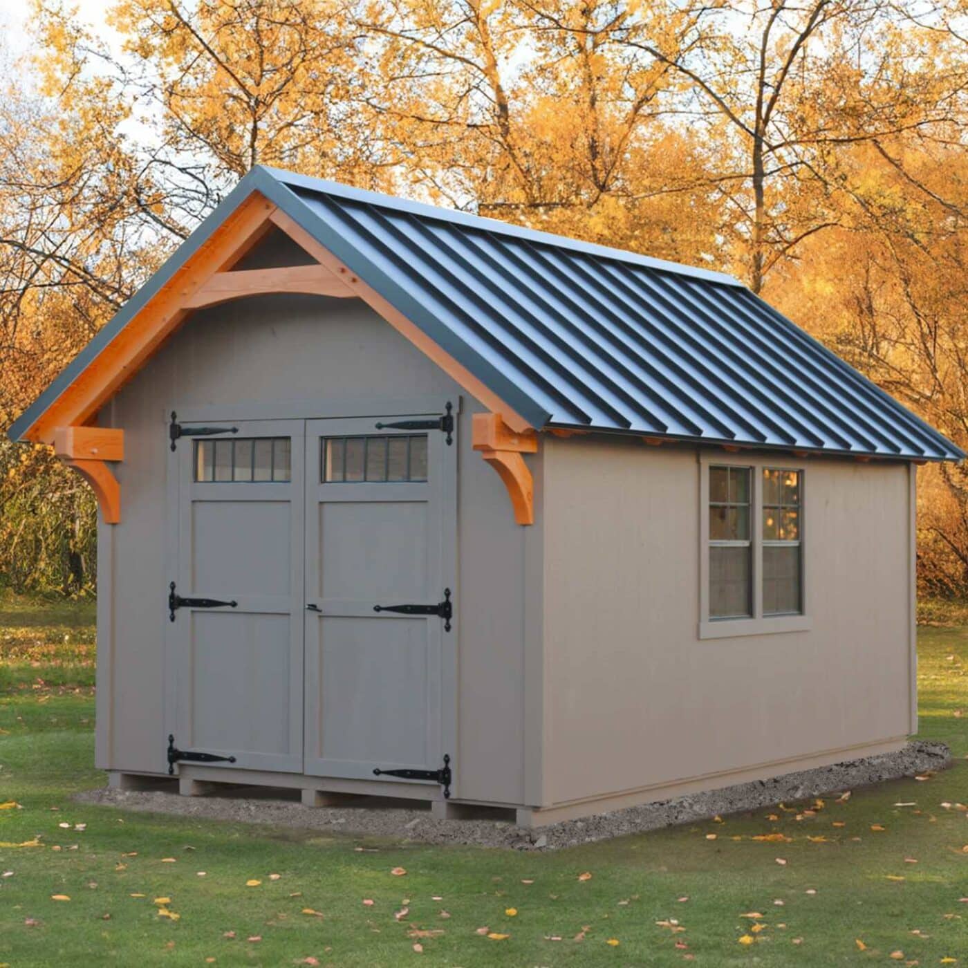 The Lancaster Shed 4 Gray Lancaster Shed in front of autumn leaves with double door and single window