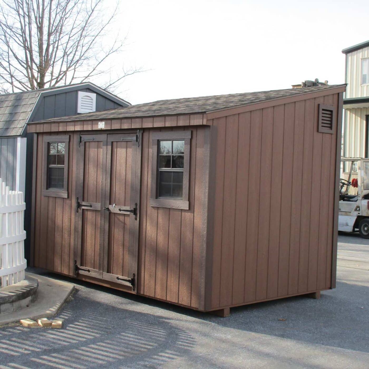 The Lean-To Shed 4 Lean-To shed with wood exterior with dark brown trim and brown siding in lot with other sized sheds