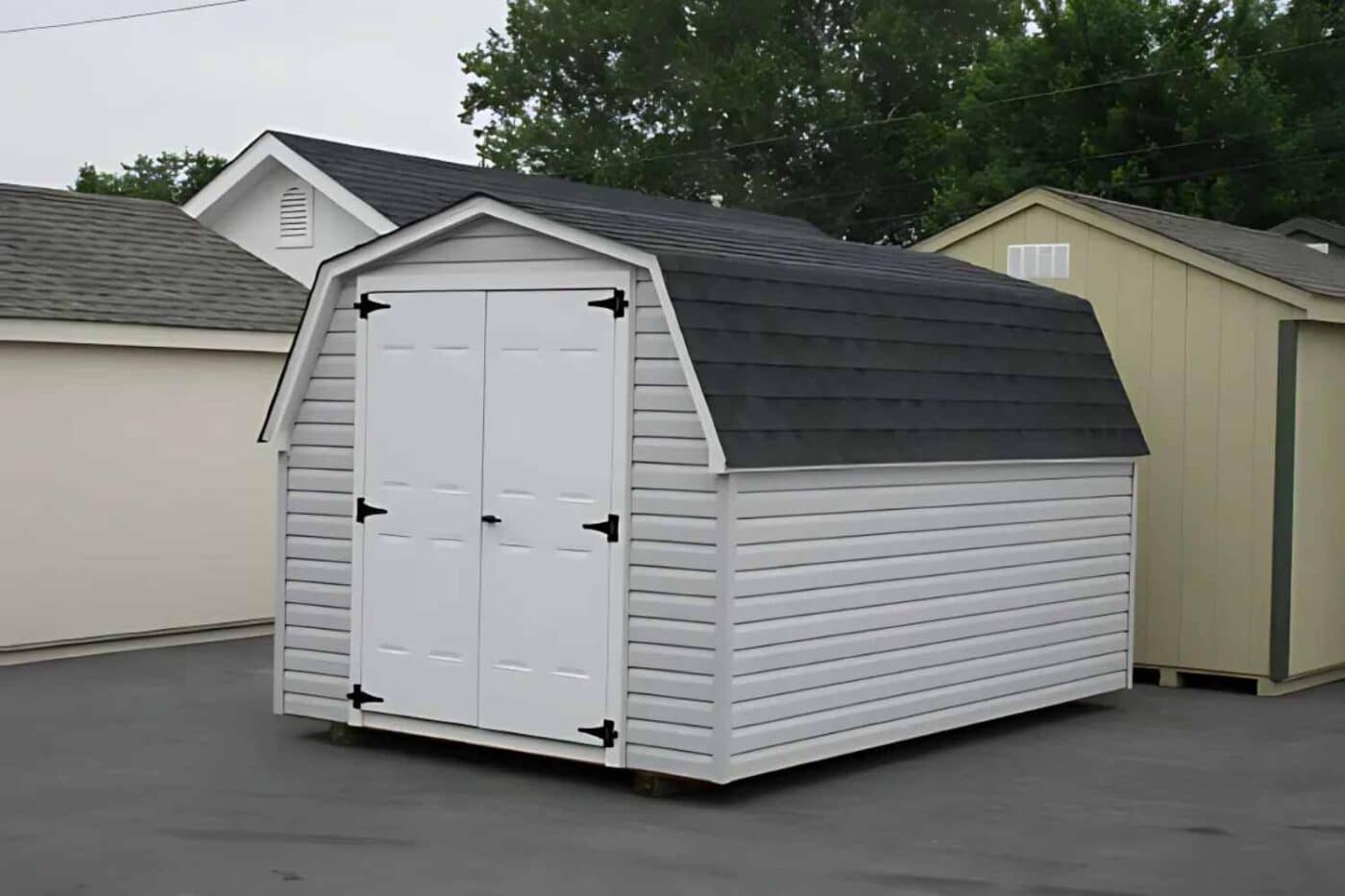 Gray and white mini barn with dark gray roof