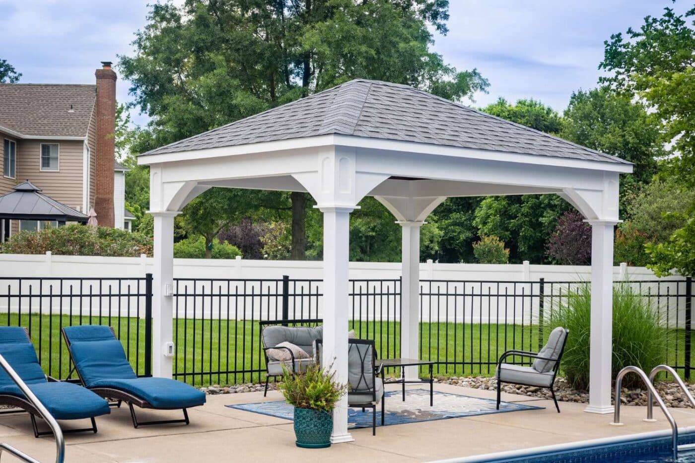 Shoreline elegant outdoor living vinyl pavilion over seating area and besides pool