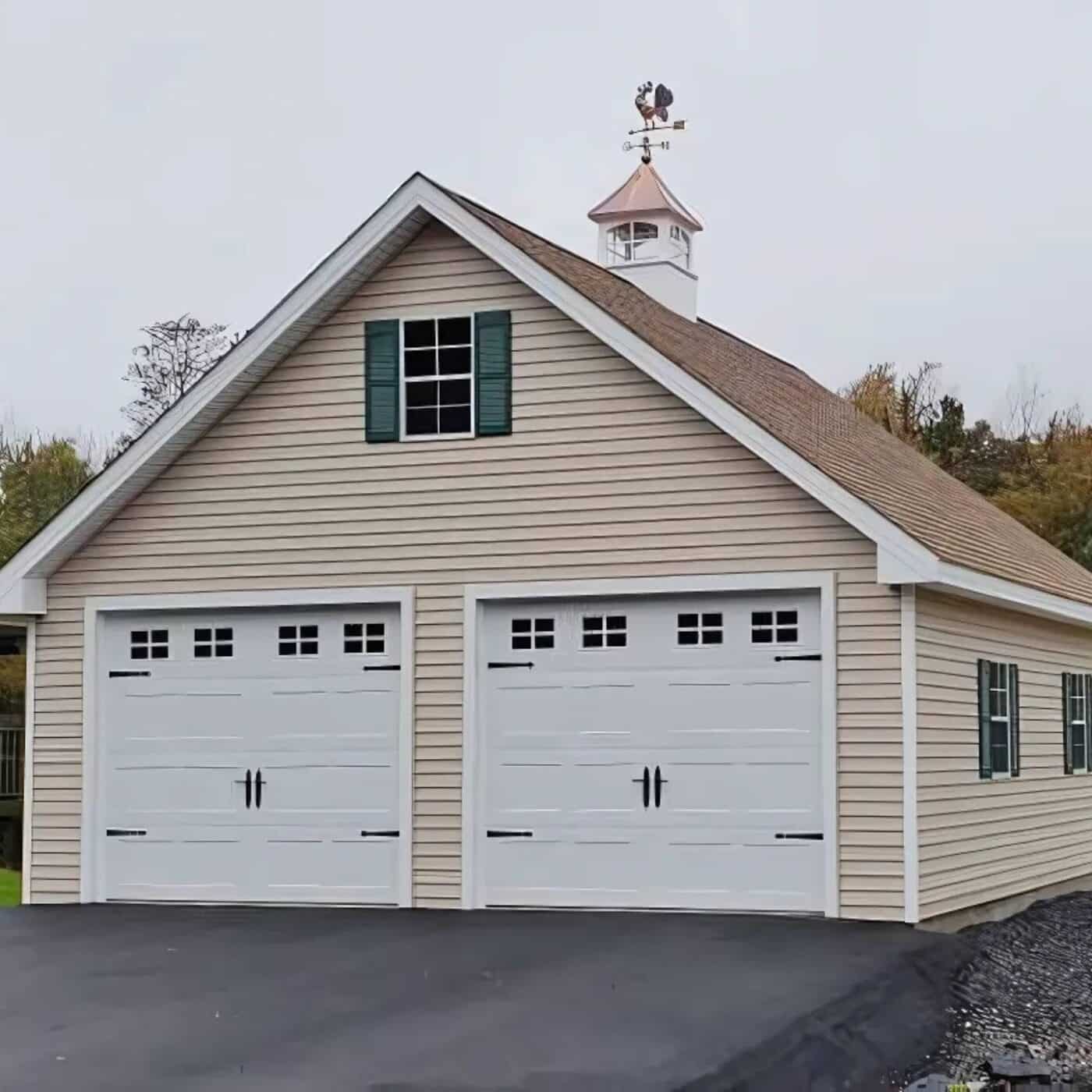 The A-Frame King Garage 4 A-frame garage with beige siding and white garage doors/trim and green shutters