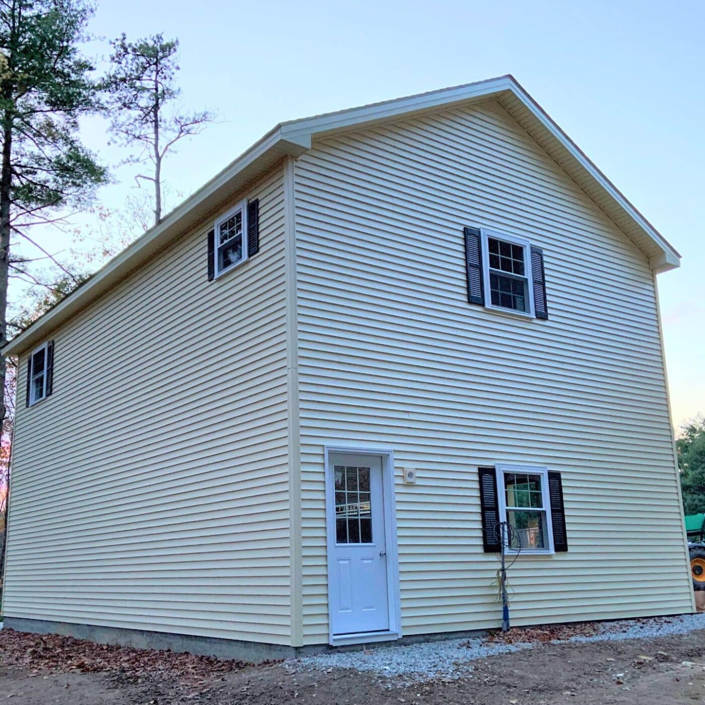The A-Frame Two Story Garage 4 View of two-story garage at sunset with window and roof trim in view