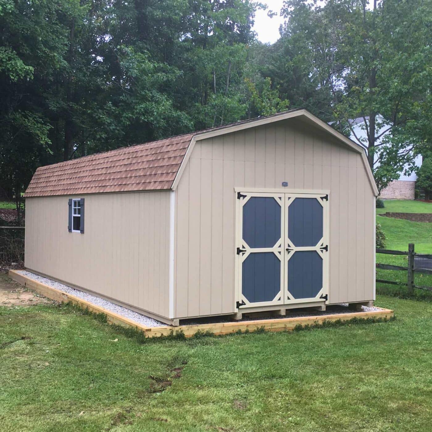 The Standard High Barn Shed 6 Beige high barn with blue doors and white trim