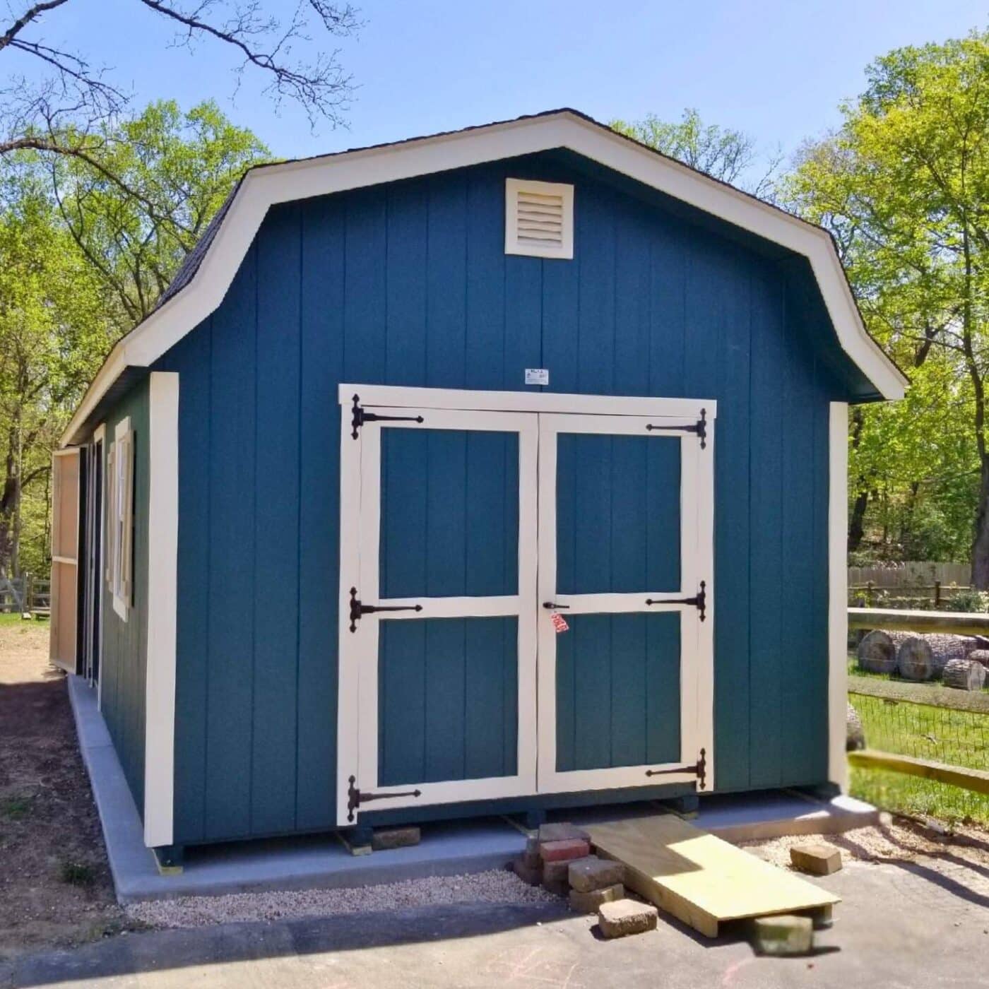 The Designer High Barn Shed 6 Blue high barn designer shed from front with view of double doors