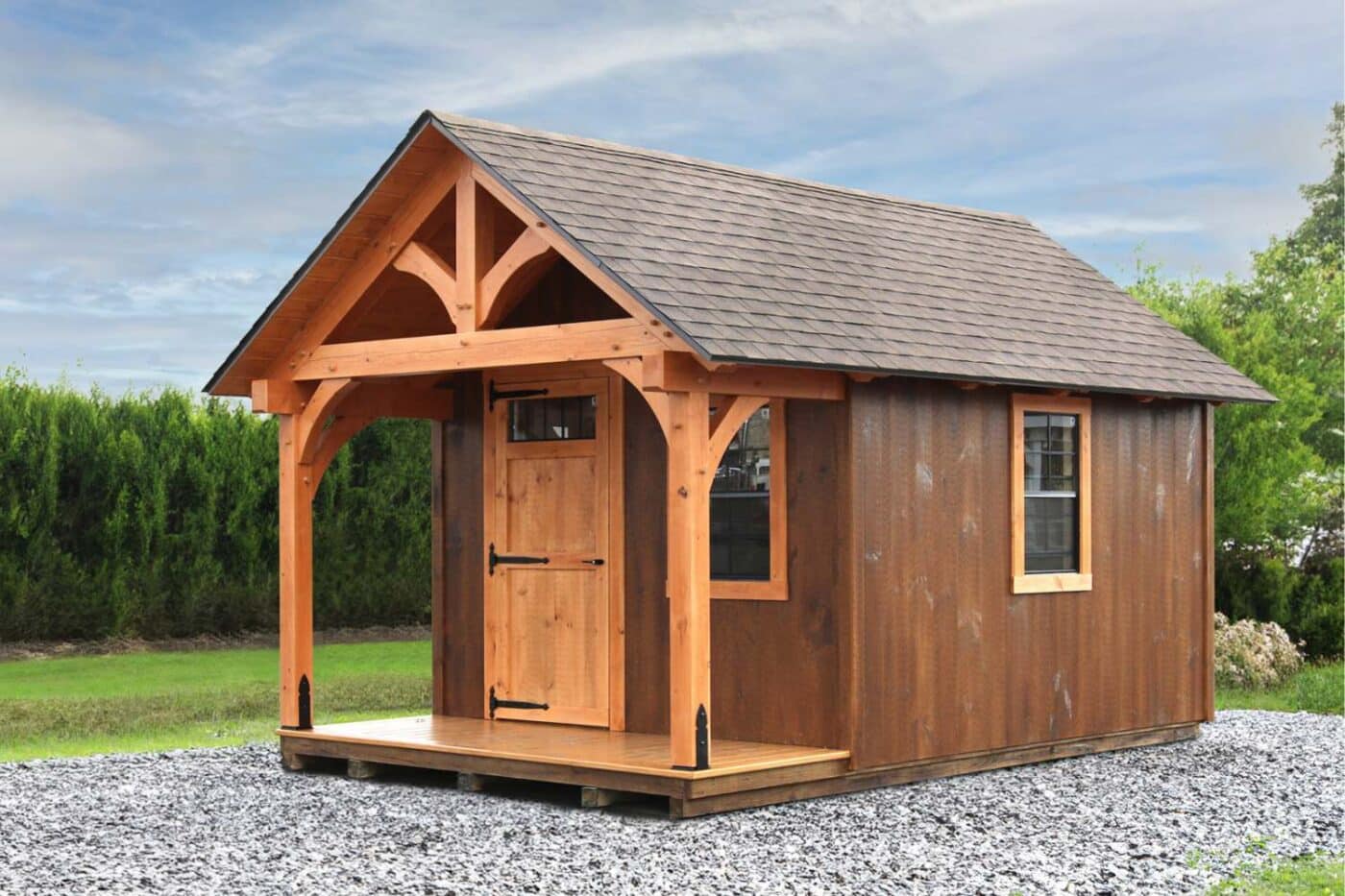 The Somerset Timber Frame Shed on gravel foundation with brown siding, wooden porch and door