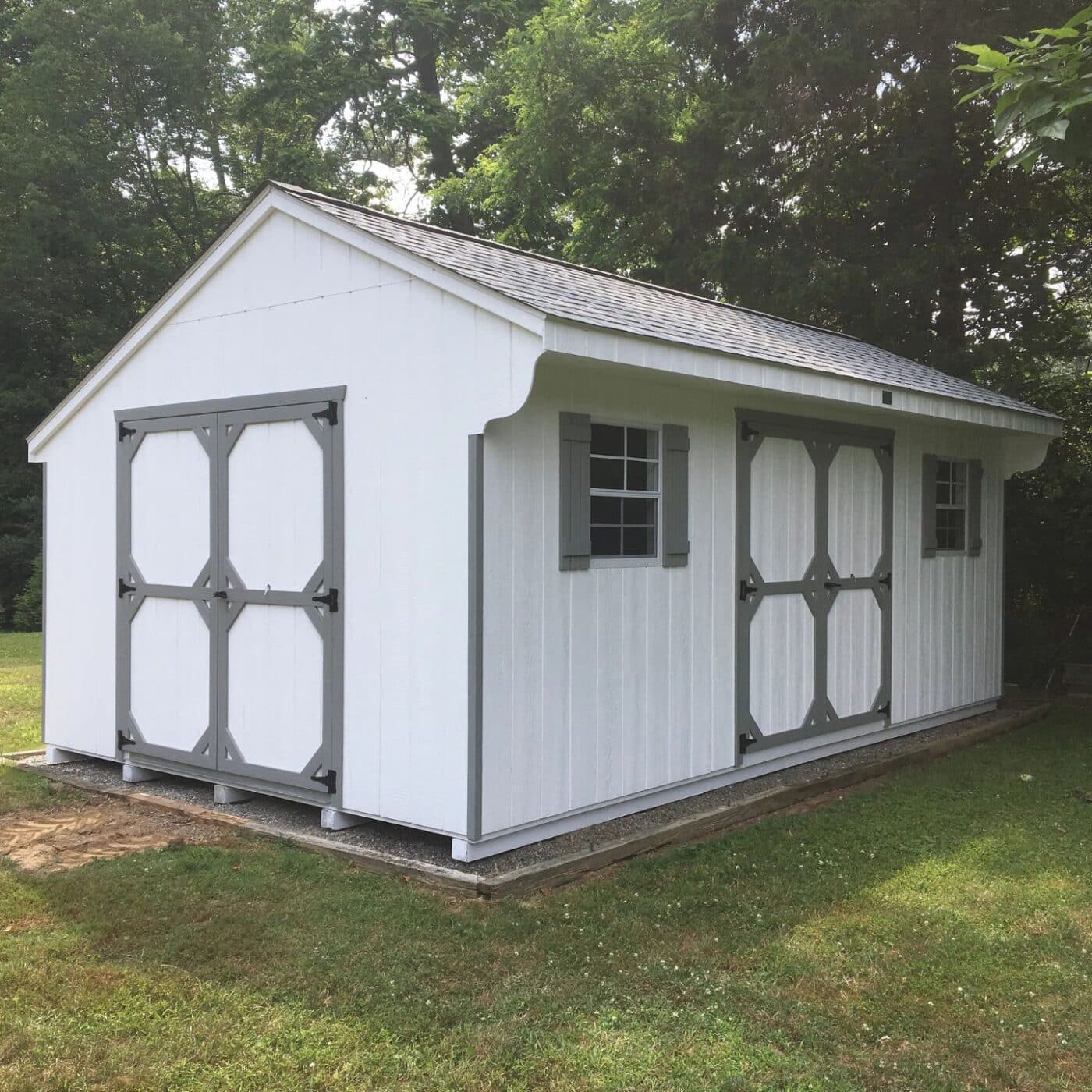 The Standard Carriage Shed 6 White and grey standard carriage shed on gravel foundation