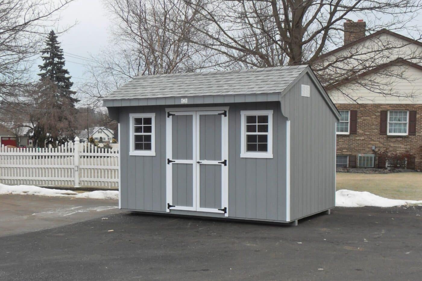 The Standard Carriage Shed 4 Gray carriage shed with white trim and two windows