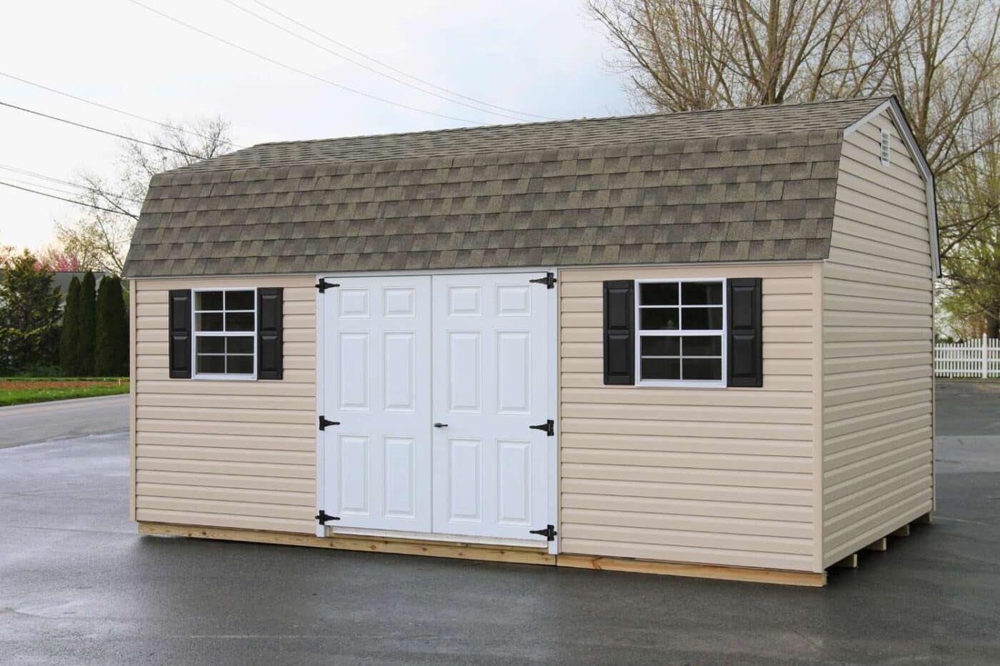 The Standard High Barn Shed 5 Beige vinyl standard high barn shed on concrete pad