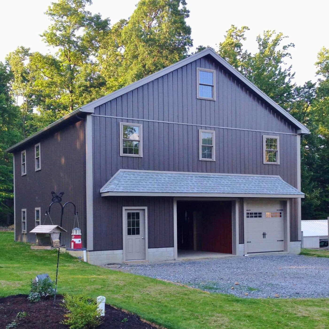The A-Frame Two Story Garage 3 Brown garage in backyard with two doors, and windows facing viewer