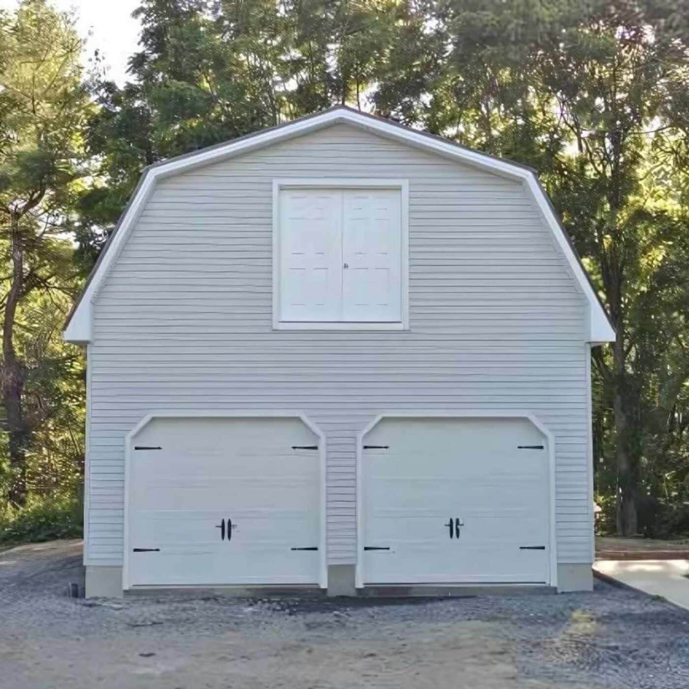 The Gambrel Garage 3 White gambrel garage showing standard materials on gravel driveway