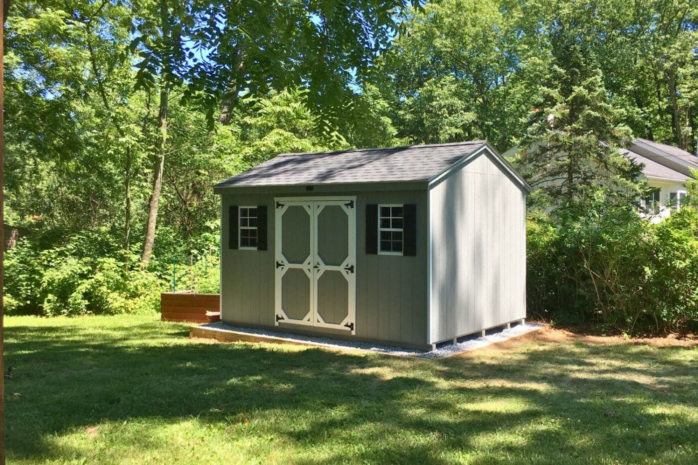 Standard Workshop Shed dappled in sunlight on gravel pad