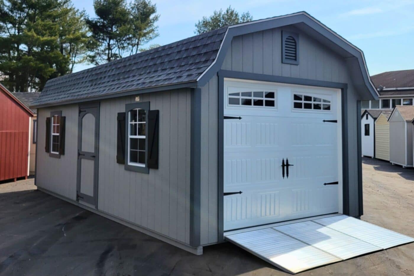 The Designer High Barn Garage 2 Gray and white designer high barn garage shed with dark trim and metal ramp