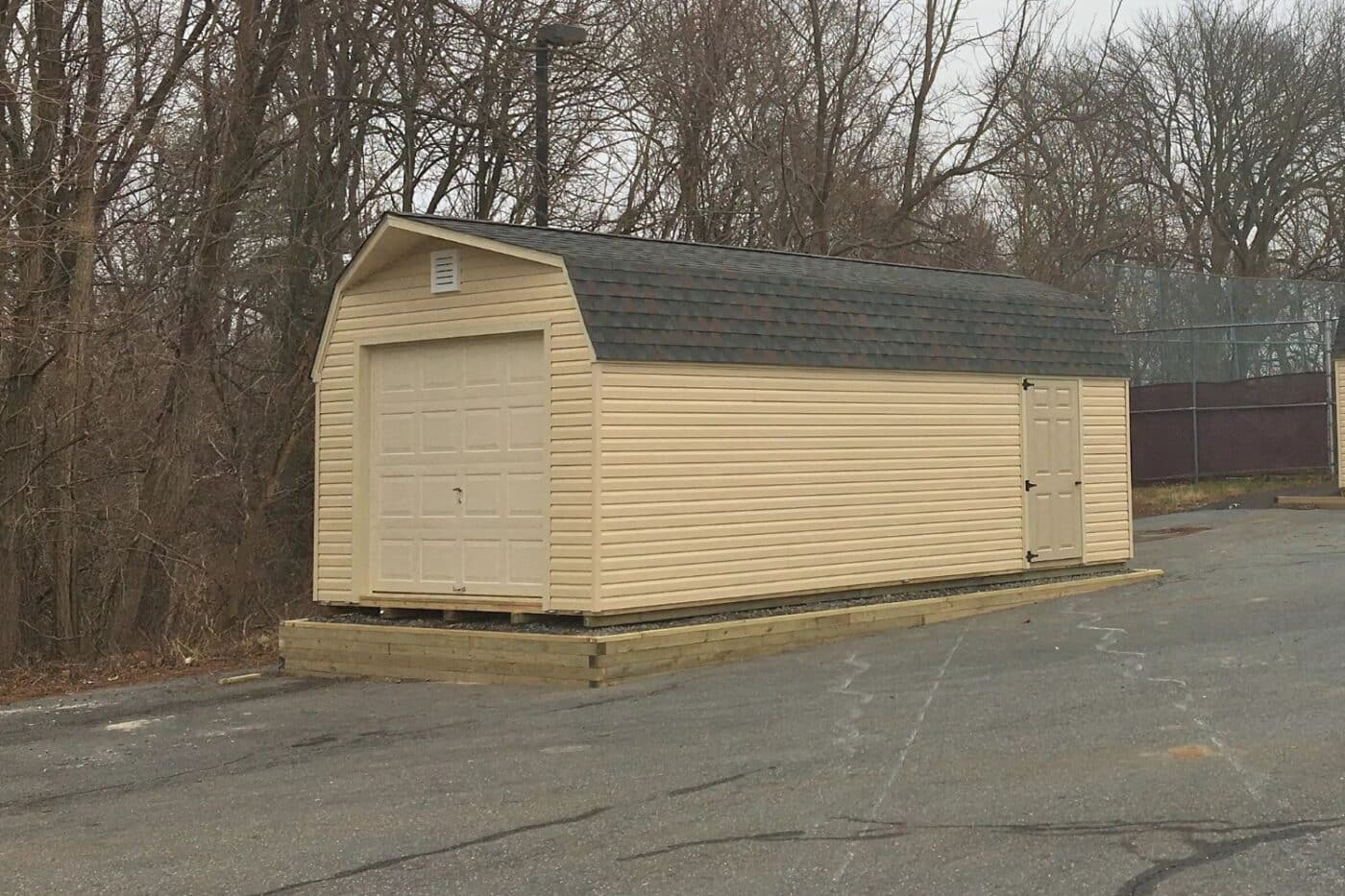 The Standard High Barn Garage 3 Standard High Barn Garage shed with a vinyl exterior