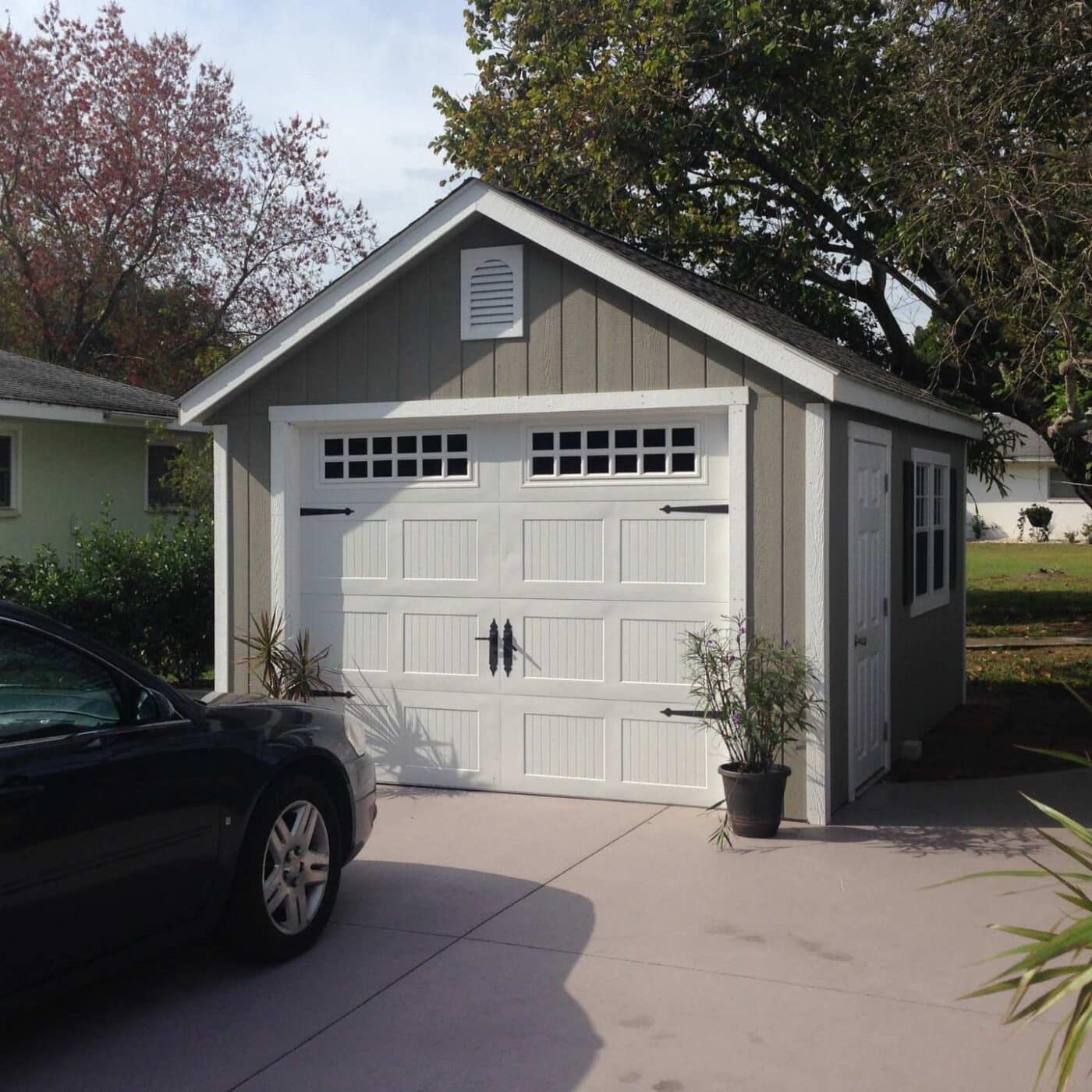 The Standard Workshop Garage 4 Gray garage shed with white garage door and trim