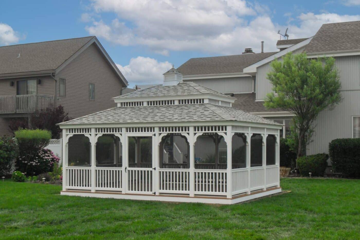 Vinyl rectangle gazebo behind house with double roof, cupola, and screened in porch