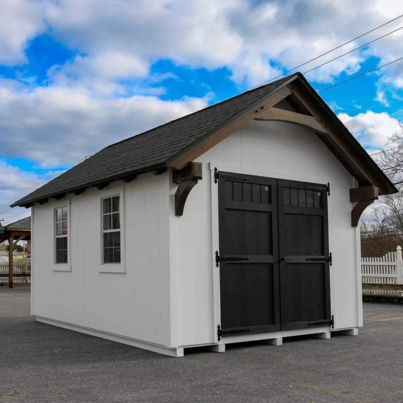 The Lancaster Shed 6 Black and white lancaster shed with view of two single windows on side and double door with transom window on front