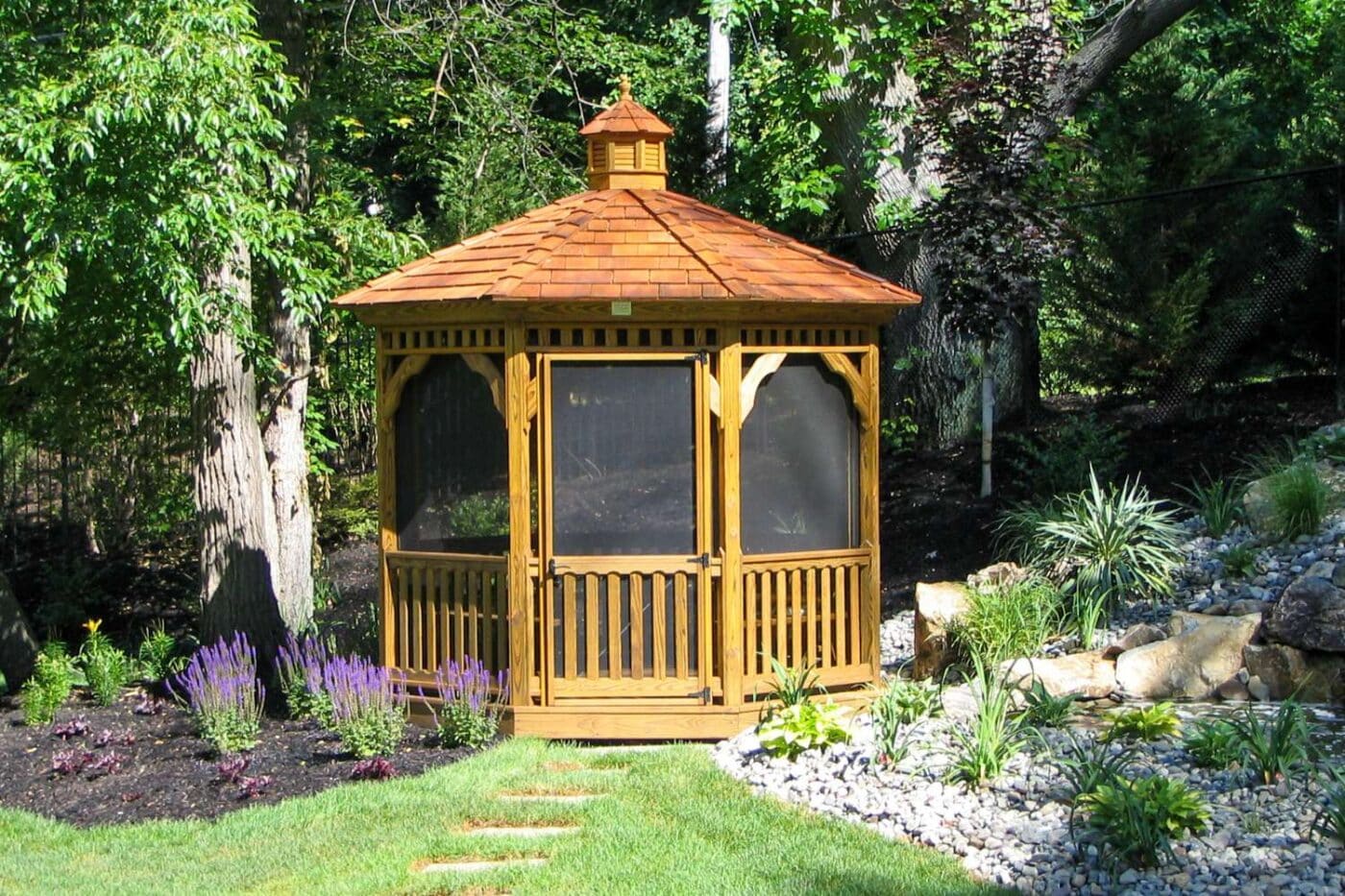 Wood octagon gazebo in garden with cupola and screened in windows